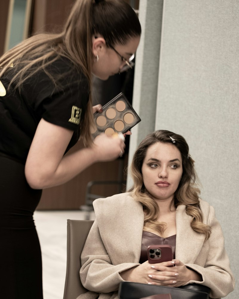 Makeup artist lucrând cu o clientă